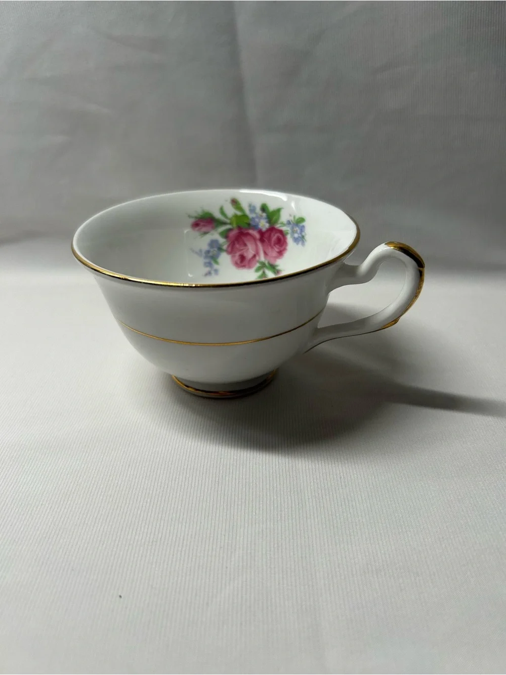 Classic White Porcelain Teacup with Pink Rose Detail and Gold Trim